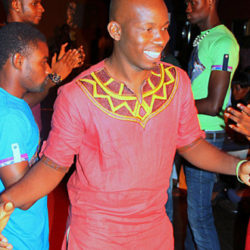 Atsu Numadzi pictured candidly at a party wearing a red shirt